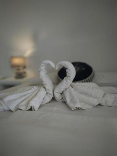 a pile of towels sitting on top of a bed at Anatoli Studios in Schinoussa