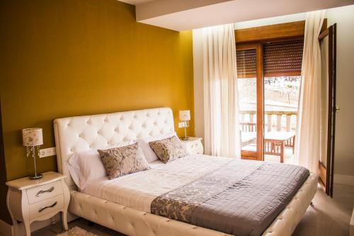 Ένα ή περισσότερα κρεβάτια σε δωμάτιο στο Casa Rural Terra Santa