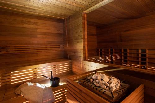 a sauna with a bench in the middle of it at Relais Mont Blanc Hotel & Spa in La Salle