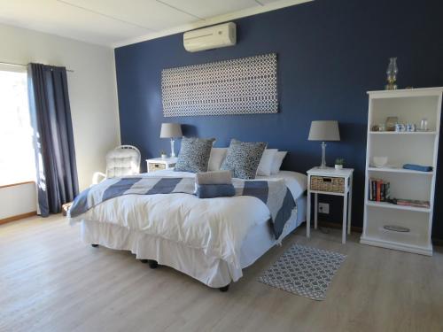 Ένα ή περισσότερα κρεβάτια σε δωμάτιο στο Koraalboom Guesthouse