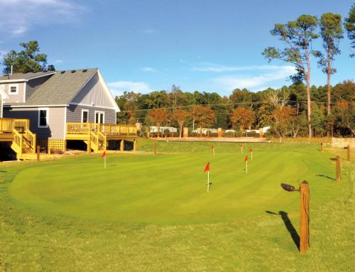 a golf course with a putting green with flags at Kilmarlic Bubba Watson in Powells Point