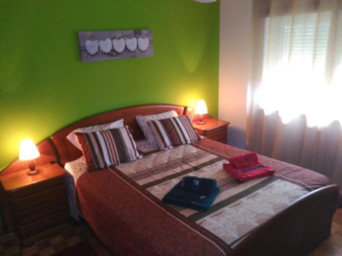 a bedroom with a large bed with green walls at Apa Quinta de Fora in Viseu