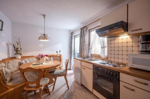 a kitchen with a table and a dining room at Gästeheim Auwitsch in Mayrhofen