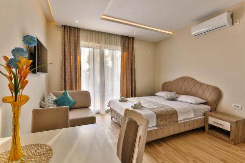 a hotel room with a bed and a table at Apolon Apart in Bar, Susanj