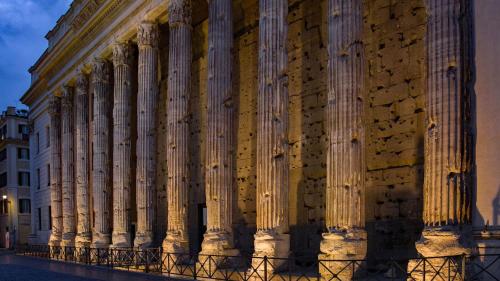 a building with columns on the side of it at Hadrianus Temple Suites - The Venue Collection in Rome