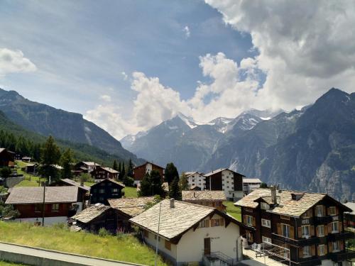 a village with houses and mountains in the background at Haus Azurit Dachwohnung Nr.30 in Grächen