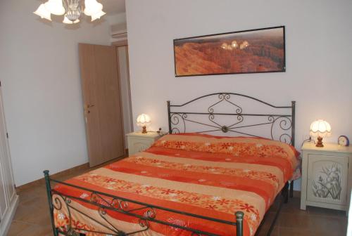 a bedroom with a bed and two night stands at Attico La Murighessa in Castelsardo