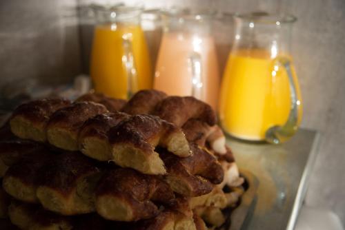 a pile of waffles on a plate next to orange juice at Hotel King's in Mar del Plata