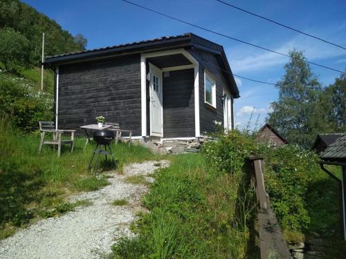 a small house with a grill in front of it at Voss- Myrkdalen Lodge in Vossestrand