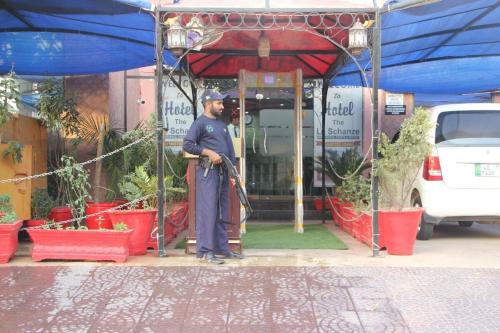 a police officer standing in front of a building at Hotel The Leschanze in Lahore