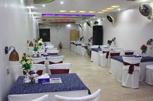 a banquet hall with tables and chairs in a room at Hotel The Leschanze in Lahore
