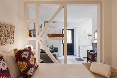 a living room with a white couch and a stairway at Typical and Brand New T.M. Flat in Lisbon
