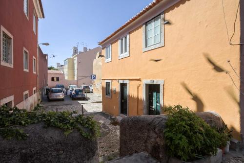 a building with a car parked next to a street at Typical and Brand New T.M. Flat in Lisbon