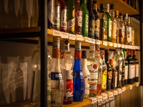 a shelf filled with lots of bottles of alcohol at Cicha Zdrój in Solec-Zdrój