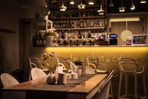 a table with vases and flowers on it in a restaurant at Cicha Zdrój in Solec-Zdrój