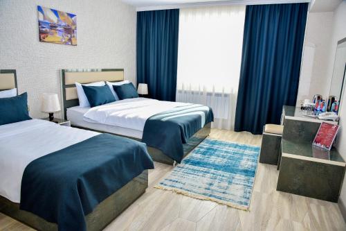 מיטה או מיטות בחדר ב-Supreme Hotel Baku