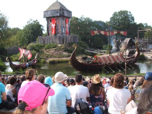 a crowd of people watching a show with a boat at Chambres d'hôtes La Charrière in Cheffois