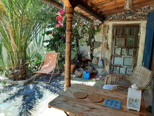 an outdoor patio with a wooden table and chairs at casa limon, El Guro in Valle Gran Rey