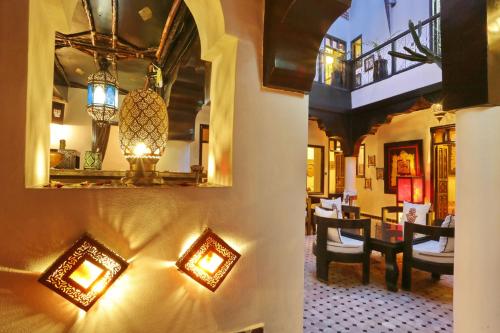 a living room with a table and a dining room at Dar Najat in Marrakech