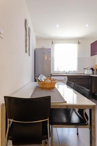 a kitchen with a table and chairs in a kitchen at Pinewood in St Julian's