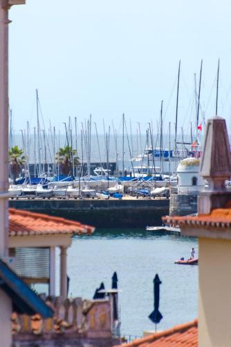 a marina with boats in the water and buildings at Sta Catarina - Cascais Beach Apartments in Cascais