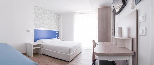 a bedroom with a bed and a desk in it at B&B FLORE in Torre Maggiore