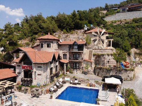 an aerial view of a house with a swimming pool at The Stone Castle Boutique Hotel in Ağaçlı