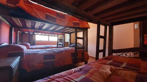 two bunk beds in a room with at Bolivian Heights Hostel in La Paz