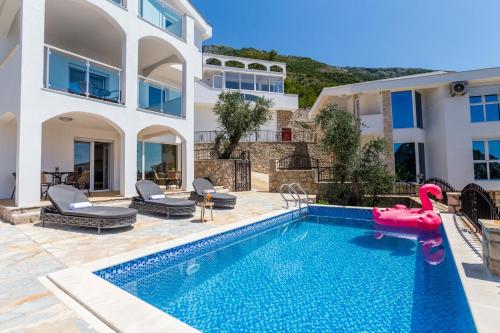 a villa with a pool and a water slide at Dolaca Villas in Sutomore