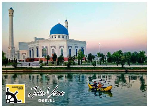 a group of people in a canoe in front of a mosque at Jules Verne Hostel in Tashkent
