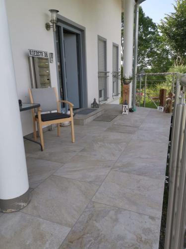 a patio with a table and chairs on a building at Haus Stegmeir in Hohenweiler