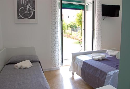 a bedroom with a bed and a sliding glass door at Valente rooms in Agropoli
