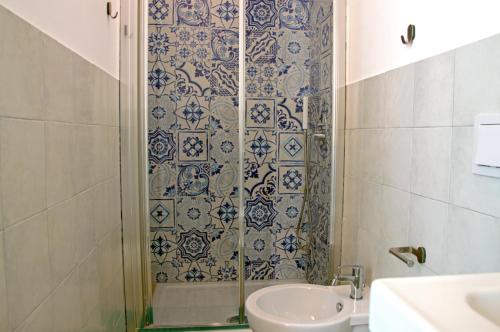 a bathroom with a shower and a toilet and a sink at Valente rooms in Agropoli