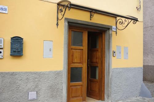 a building with a wooden door in front of it at La Piccola Oasi Toscana in Bagni di Lucca
