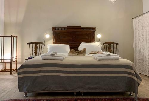 a bedroom with a large bed with towels on it at Villa Vager Mani Hotel in Kalamata