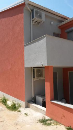 a red and white building with a stove at Novalja centar in Novalja