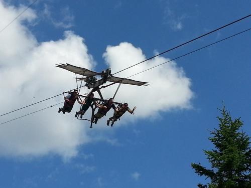 a group of three people hanging from a helicopter at Ferienhof Kampfl in Fügen