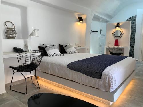 A bed or beds in a room at Timedrops Santorini Villas