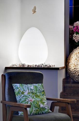 a chair with a pillow in front of a mirror at Hotel Erika in Malcesine