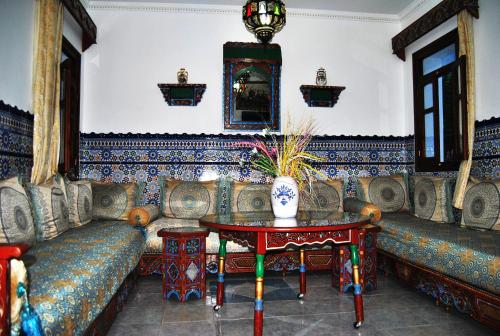 a living room with a couch and a table at Hotel Casa Khaldi in Chefchaouen