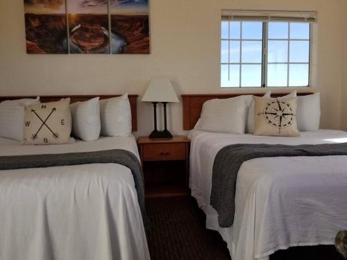 a hotel room with two beds with clocks on them at 071B Private Studio near Grand Canyon South Rim Sleeps 6- No Kitchen in Valle