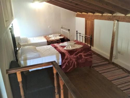 two twin beds in a room with a staircase at RIVER HOUSE MARIA in Lefkimmi