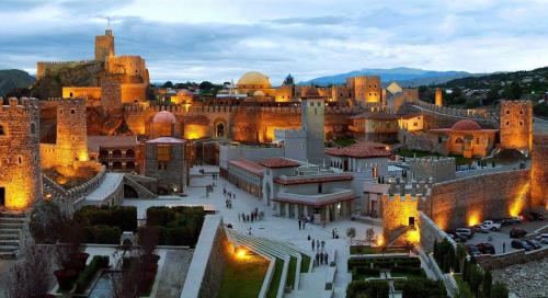 a view of a city with a castle at night at tomas kokhi in Akhaltsikhe