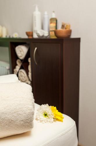 a close up of a bed with flowers on it at Hotel & Spa Polesie in Białka