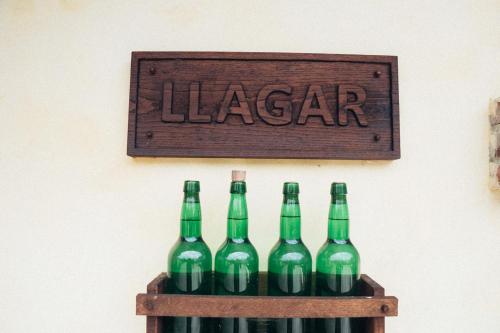 a group of green bottles of wine on a shelf at La Montaña Mágica Hotel Rural in Vibaño