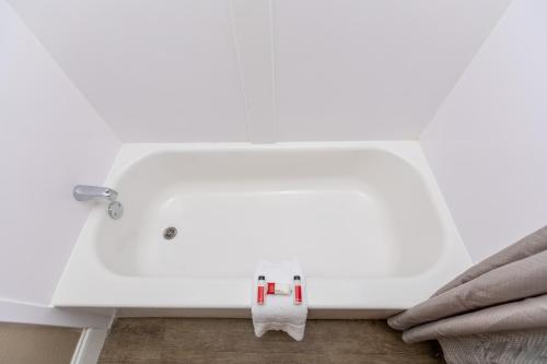 a white sink with a towel hanging from it at Super 8 by Wyndham Goldsboro in Goldsboro