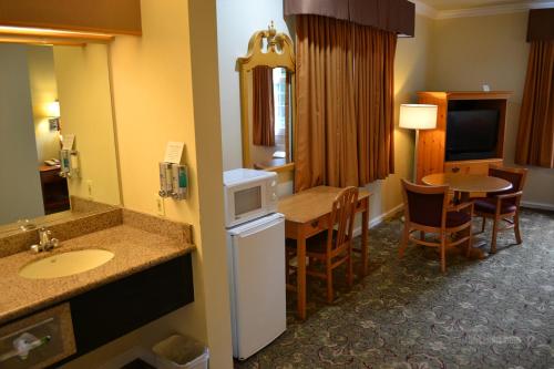 a hotel room with a kitchen and a dining room at The Miramar Inn & Suites in Half Moon Bay