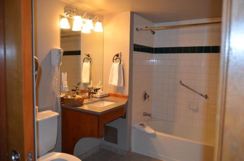 a bathroom with a sink, toilet and shower at Howe Sound Inn & Brewing Company in Squamish