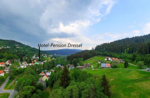a town on a hill with a sign that reads hotel permission diverted at Hotel-Pension Dressel in Warmensteinach