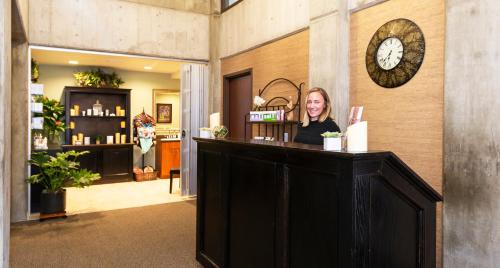 a woman sitting at a counter in a store at Alta's Rustler Lodge in Alta